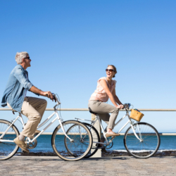 Couple on bikes by seaside