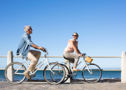 Couple on bikes by seaside