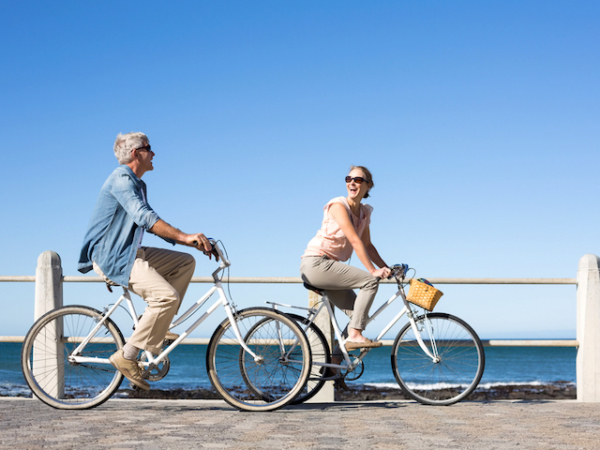 Couple on bikes by seaside